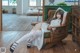 A woman sitting in a chair in a room.