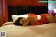 A woman laying on a bed in a red dress.