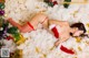 A woman in a red lingerie laying on a pile of snow.