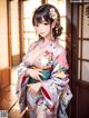 A woman in a kimono posing for a picture.